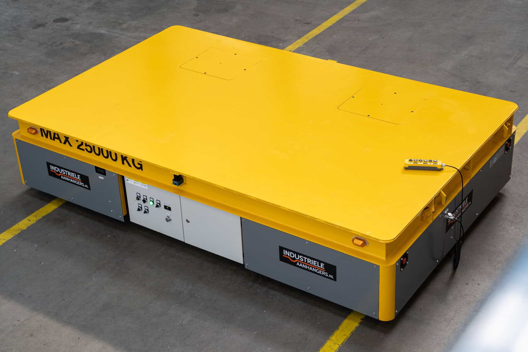 Top view of a yellow HULCK 25-tonne platform mover with wired remote control